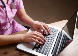 Nurse Typing On Computer