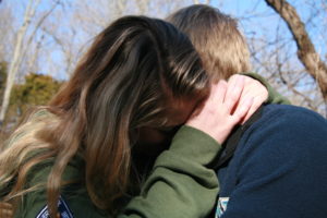 two young people hugging