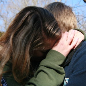 two young people hugging