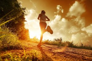 young woman jogging in morning sunlight