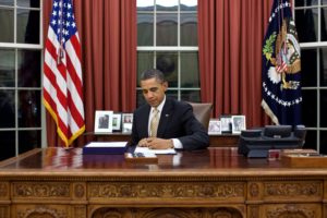 President Barack Obama signs H.R. 3630 - Middle Class Tax Relief and Job Creation Act of 2012 in the Oval Office, Feb. 22, 2012. (Official White House Photo by Pete Souza) This official White House photograph is being made available only for publication by news organizations and/or for personal use printing by the subject(s) of the photograph. The photograph may not be manipulated in any way and may not be used in commercial or political materials, advertisements, emails, products, promotions that in any way suggests approval or endorsement of the President, the First Family, or the White House.