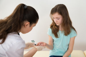 Doctor Measuring Blood Sugar Level Of Girl