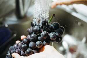 washing grapes with water, food preparation, food prep